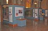 View of the gallery showing a national color carried by the 7th Regiment, NYS Militia (left), and the “Prince of Wales” flag carried by the 69th Regiment, NYS Militia.