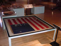 Eastern view of the exhibit with the 186th Regiment's national color in foreground