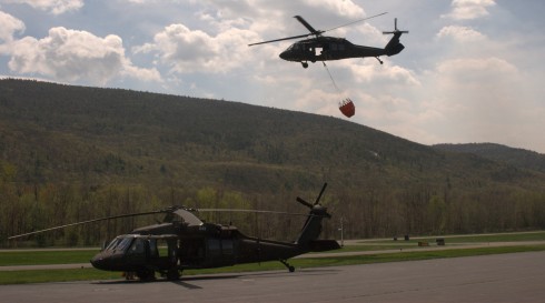 A UH-60 Blackhawk from the Army Aviation Support Facility in Latham heads out on a fire supression mission on Tuesday, May 5 while another UH-60 gets ready to go. Two UH-60 Blackhawk helicopters and crews assisted in fighting a forest fire in Shawangunk R