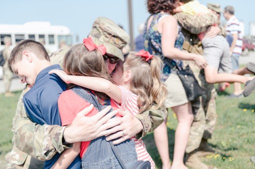 New York Army National Guard Maj. Adam Bajorski  the operations  officer for the 27th Infantry Brigade Combat Team hugs his children after returning from a 10 month deployment to Ukraine Niagara Falls Air Reserve Station N.Y. Aug. 23 2018. Bajorski came h