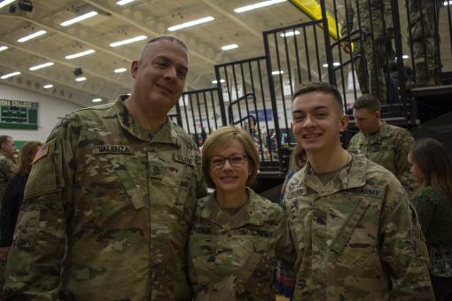 New York Army National Guard Sgt Andrew Valenza (right) is joined by his parents, Major Julie Valenza and Sgt. 1st Class William Valenza as they prepare to deploy together during the 42nd Infantry Division farewell ceremony held on January 11, 2020, at Si