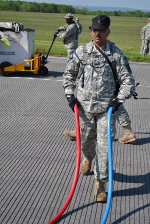 New York State Preparedness Training Center -- Oriskany, NY -- New York Guard Staff Sgt. Francisco Hernandez of the 88th Brigade is seen unraveling hot and cold water hoses used in the decontamination tent, during the Homeland Response Training, here, May 16. The state guard members train alongside their New York Army National Guard counterparts to respond to chemical emergencies per executive order of the New York State Governor.  

