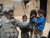 First Sergeant Ron Patterson from Gloversville, NY assigned to Security Force Battalion (SECFOR) Company C hands toys to Afghan children during a humanitarian assistance operation in a village in Kabul province.  U.S. Army photo by Captain (Chaplain) Alex Knowles (released.)