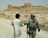 An Afghan teen shakes the hand of 1SG Ron Patterson as the SECFOR prepares to depart Khata Kheyl.