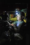SFC. Kevin Taylor from Utica loads information into his Blue Force tracker from inside the M1151 Uparmored humvee prior to the mission.