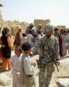Afghan Boys approach Specialist Cristyan Valentine from the Bronx during the HA mission.