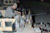 SPC. Robert Collins from Lockwood, NY lubricates his M2 .50 cal machinegun from his gunners position in an M1151 Up armored Humvee