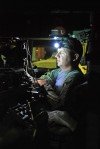 SFC. Kevin Taylor from Utica loads information into his Blue Force tracker from inside the M1151 Uparmored humvee prior to the mission.