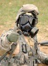 A Soldier from the 27th Brigade Combat Team practices firing his weapon in a contaminated environment during October 2007 Annual Training