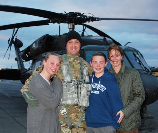 New York Army National Guard Soldier Chief Warrant Officer 5 Chris Panarese poses with his wife Laura and children Samantha and Johnathan at the Army Aviation Support Facility #3 in Latham, N.Y. on Nov. 29, 2018 following Panarese 