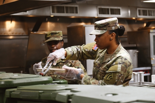 FORT INDIANTOWN GAP, Pennyslvania-New York Army National Guard Spc. Lenae Davis, left, and Pfc. Jaida Sheppard,culinary specialists assigned to the 42nd Infantry Division prepare breakfast during a drill weekend at Fort Indiantown Gap P.A. April 21 2023. 