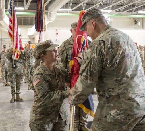 Lt. Col. Katie Schin accepts the unit guidon from Brig. Gen. Joseph Biehler commander of the 42nd Infantry Division as she takes command of the 42nd Inf. Div.s Headquarters and Headquarters Battalion during a ceremony July 13 2024 at the New York Army Nat
