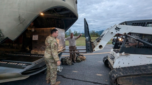 SYLVA, NORTH CAROLINA--New York Army National Guard Staff Sgt. Sam Sacco works with Jackson County public works employees to offload food and water from a New York Army National Guard CH-47 at the Jackson County Airport in Sylva North Carolina on October 