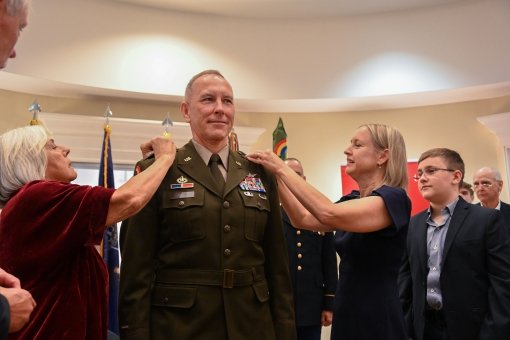 CAMP SMITH--New York Army National Guard Major General Jack James receives his new rank from family friend Lisa Dicandido,left and his wife Lesia during promotion ceremonies held on October 19 2024 at Camp Smith Training Site near Peekskill New York. Jame