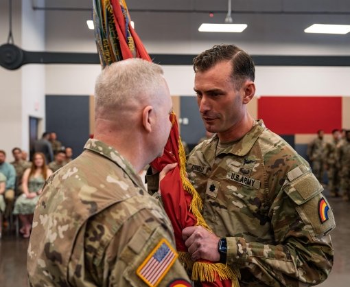 QUEENS--Lt. Col. Adam Connolly right accepts the flag of the 1st Battalion 258th Field Artillery Regiment from Col. Jeffery Roth commander of the 42nd Infantry Division Artillery during change of command ceremonies on May 16 at the Jamaica Armory in Queens New York. Connolly replaces Lt. Col.Eric Emerling who is retiring after 20 years of service. 