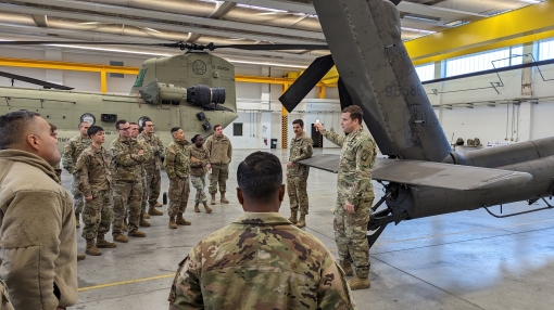  New York Army National Guard Soldiers assigned to the Joint Military Training Group-Ukraine listen as Army 1st Lt. Sean Schlagel an aviation officer assigned to Bravo Company 1st Battalion 3rd Aviation Regiment (Attack Battalion) gives an overview of the