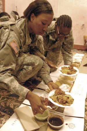 Pfc. Jolie Powell, a Queens, N.Y., native and member of the 2nd Battalion, 108th Infantry Regiment&rsquo;s Female Engagement Team, learns how to dine politely during an Afghan meal during pre-mobilization training May 31 in Fort Drum. &ldquo;They just said we&rsquo;re supposed to speak to the women, see how they feel, if they need medicine or anything,&rdquo; Powell said of the FET team&rsquo;s mission during their upcoming deployment to Afghanistan.