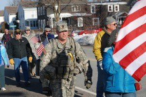 GLENS FALLS, N.Y. - New York Army National Guard Sgt. 1st Class Jason Springer from Glens Falls, N.Y. participates in the 10th annual Christmas Eve Roadmarch here Dec. 24. Springer was one of the original members of the 2nd Battalion, 108th Infantry deployed to Iraq when the event began in 2004. He has since been part of all but one Christmas Eve events. Participants from the New York Army and Air National Guard, veterans organizations, family members and community supporters turned out for the 3.6 mile march through town to support deployed servicemembers around the world. More than 1,000 participants turned out for the 2013 event, saluting the original unit members of the 2nd Battalion, 108th Infantry who were deployed to Iraq in 2004 for the original roadmarch.