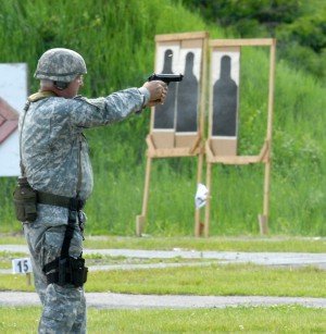 New York Guard Staff Sgt. Joseph Dee fires an M-9 pistol during the 35th Annual "TAG (The Adjutant General) Match at Camp Smith on May 31. Dee and about 125 New York National Guard members are taking part in the match, testing their marksmanship skills with weapons like the M-16 rifle, M-9 pistol and M-249 light machine gun. (U.S. National Guard photo by Sgt. 1st Class Raymond Drumsta)