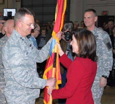 LATHAM, N.Y. -- New York State Lt. Gov. Kathleen C. Hochul (right) hands the New York State Division of Military and Naval Affairs (DMNA) colors to Maj. Gen. Anthony German (left), making him the 53rd adjutant general of the New York National Guard during achange-of-command  ceremony at DMNA here on April 7, 2016. German assumed adjutant general duties from Maj. Gen. Patrick Murphy, who became the 52nd adjutant general of New York State in 2010. 