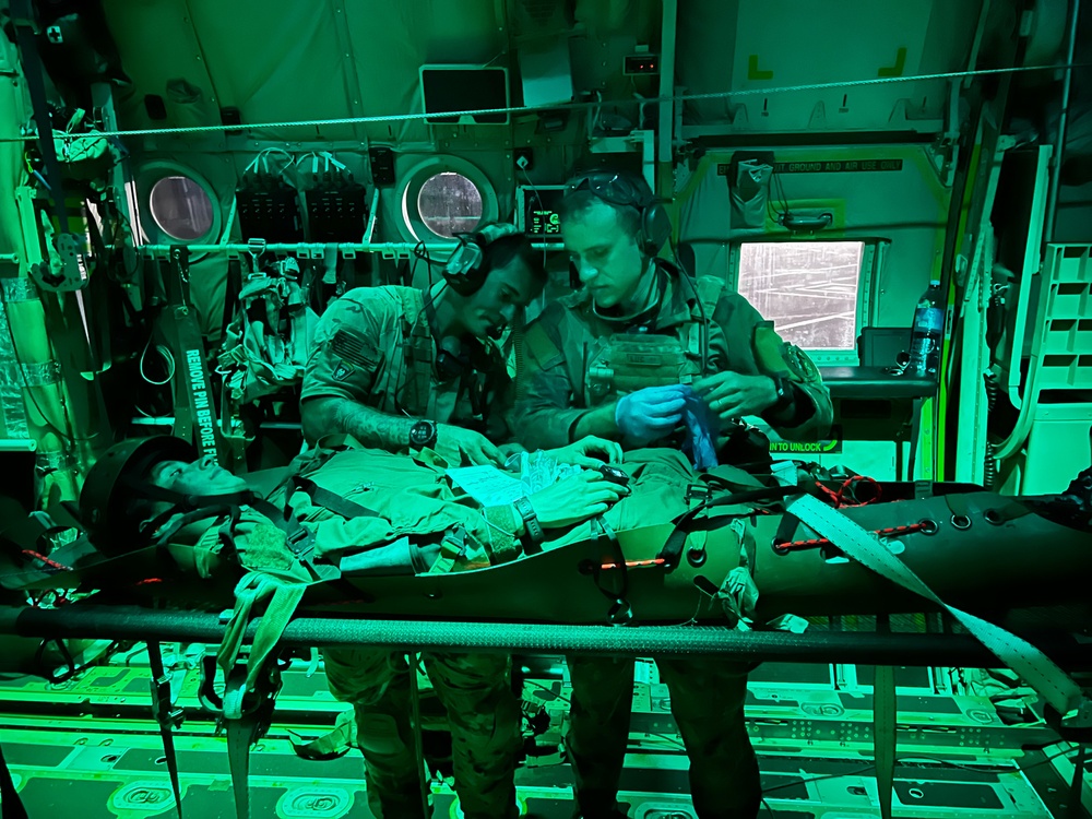
                Senior Airman Matt Pluhoeski, at right, a pararescue Airmen assigned to the 103rd Rescue Squadron of the New York Air National Guard’s 106th Rescue Squadron, works with a Brazilian counterpart, on a simulated casualty on board one of the wing’s HC-130 Combat King II search and rescue aircraft during a medical evacuation mission being conducted as part of Exercise Tapio, a joint Brazilian- U.S. training exercise, in Campo Grande, Brazil on August 24, 2022. The New York Air National Guard sent 100 personnel to participate in the exercise as part of the New York National Guard State Partnership Program relationship with Brazil.            