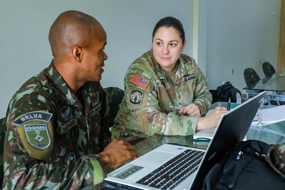 
                New York Army National Guard State Planner, Maj. Melanie Padilla works alongside her Brazilian army counterpart during the initial planning conference for exercise Southern Vanguard 24 in Macapa, Brazil, Dec 5-8, 2022. Brazil and the New York Army National Guard established a state partnership program in 2019 to enhance knowledge and training opportunities for both forces. Since its inception, the New York Army National Guard has completed over 20 exchanges, with the upcoming Southern Vanguard 24 being the largest to date. (U.S. Army photo by Maj. Tifani Summers)            