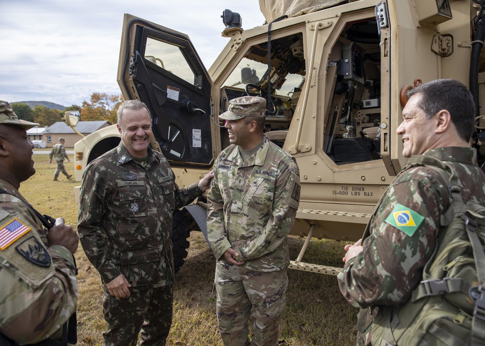 
                Lt. Gen. Achilles Furlan Neto, the Brazilian Army's Operations Officer shares a laugh with New York Army National Guard Soldiers while touring  a static display of equipment on the parade field at the Camp Smith Training Site in Cortlandt Manor, N.Y. on October 8, 2019.  Furlan visited New York Army National Guard locations in the Albany area, Camp Smith and New York City during an Oct. 6-11 visit. The New York Army National Guard has had a partnership with Brazil since March of 2019. (New York Army National Guard Sgt. Jonathan Pietrantoni)            
