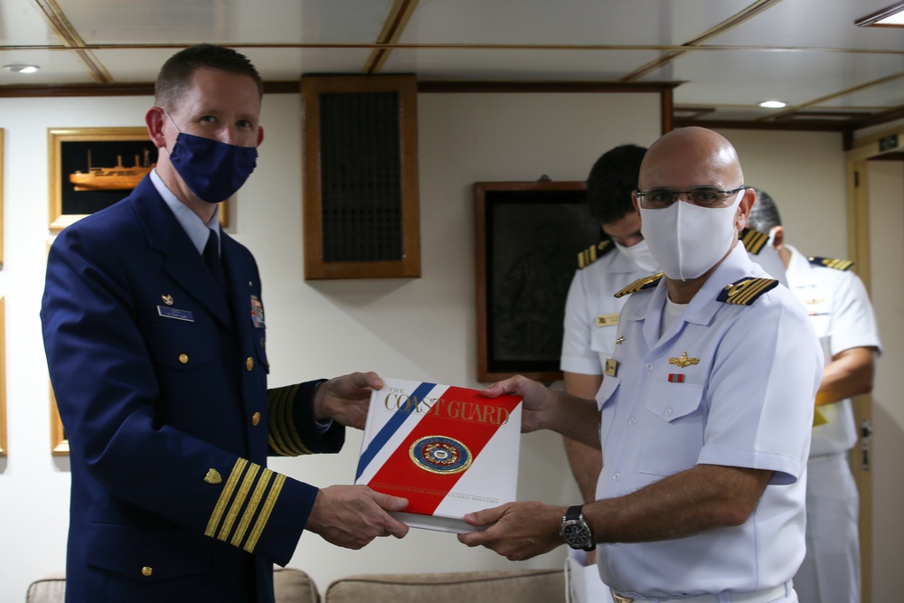 
                Coast Guard Sector Houston-Galveston Capt. Jason Smith presents a gift to Brazilian Navy Capt. Carlos Considera while visiting the Brazilian Navy Training Ship Brasil in Galveston, Texas, Nov. 19, 2020. Relationship building between foreign allies serves as a vital objective toward executing Coast Guard missions worldwide. (U.S. Coast Guard photo by Petty Officer 3rd Class Paige Hause)            