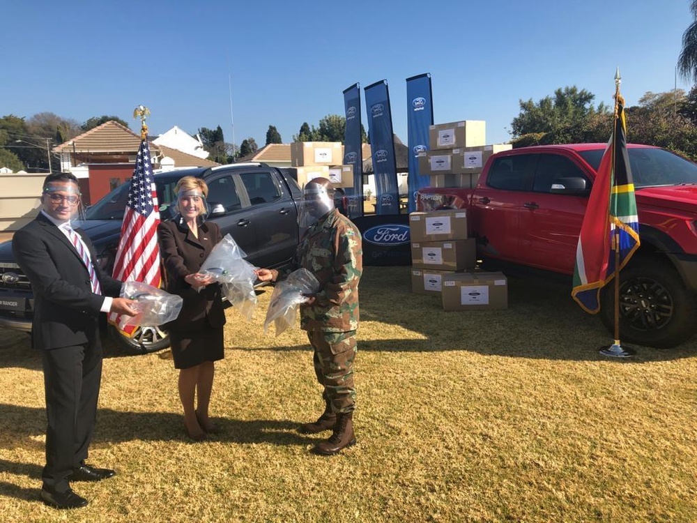 
                Officials involved in the handover of medical personal protective equipment from the United States Embassy to the South African Military Health Service at the American Community Center in Pretoria, South Africa pose for a photograph during the ceremony on June 19, 2020. Pictured are, from left, Dhiren Vanmali, Ford Executive Director of Government Affairs for Africa; U.S. Ambassador Lana Marks; South African National Defence Force Major General General Peter Maphaha. ( U.S. Army Photo by Lt. Col. Al Phillips)            