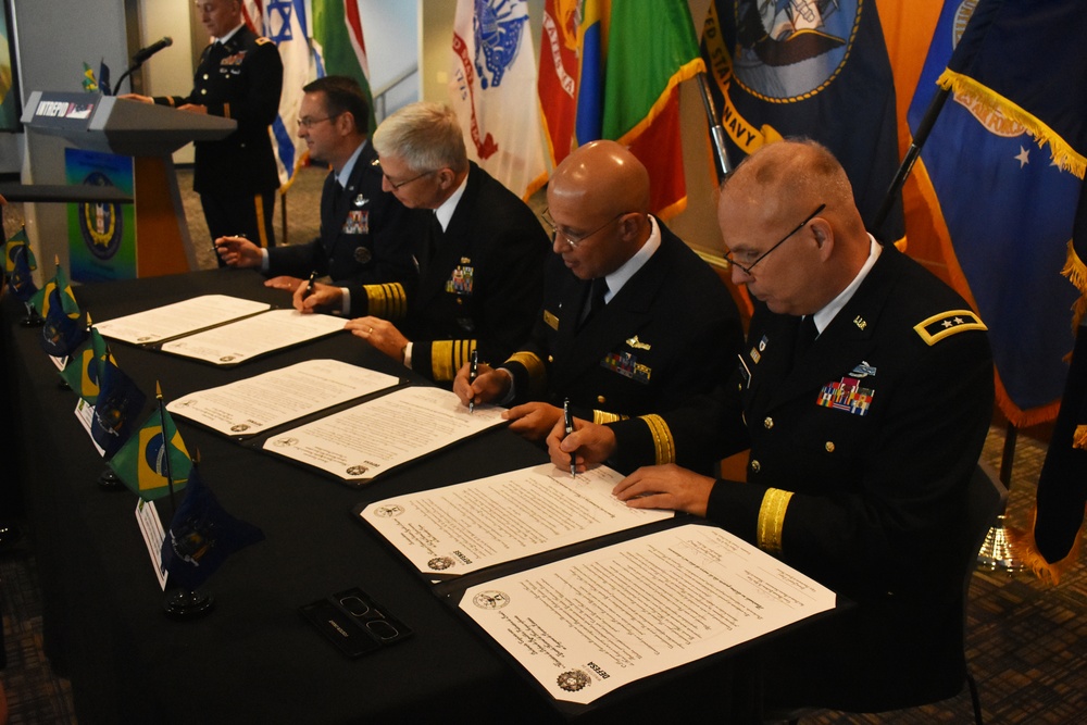 
                New York Army National Guard Soldier SSG Norma Saderi, Joint Task Force-Empire Shield, translates from English to Portuguese for a state partnership signing, on the U.S.S. Intrepid, Manhattan, N.Y., March 14, 2019. The State Partnership between the NYNG and Brazil is a Department of Defense joint security cooperation program executed by the State Adjutants General in support of Combatant Commanders and U.S. Chiefs of Mission to help achieve security cooperation objectives and Department of Defense policy goals. (N.Y. Army National Guard photo by Sgt. Andrew Valenza)            