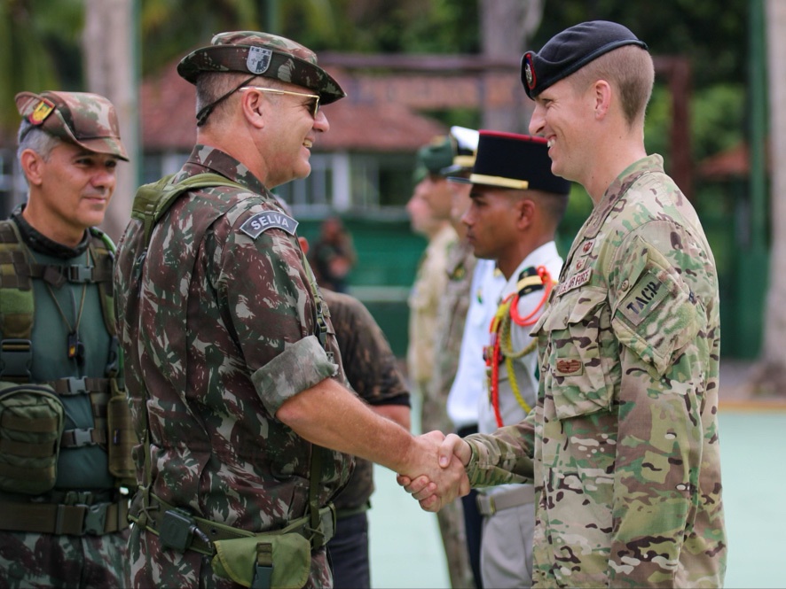 
                New York Air National Guard Tech Sgt.  Jeremy Miter, right, a member of the 274th Air Support Operations Squadron, is congratulated by the chief of Brazil’s world-famous Jungle Warfare Training School in Manas, Brazil on Nov. 17, 2022, after completing the international course taught annually by the school. Miter attended the course as part of the State Partnership Program agreement between Brazil and the New York National Guard. (U.S. Air National Guard photo by Tech Sgt. Heather Riley)            