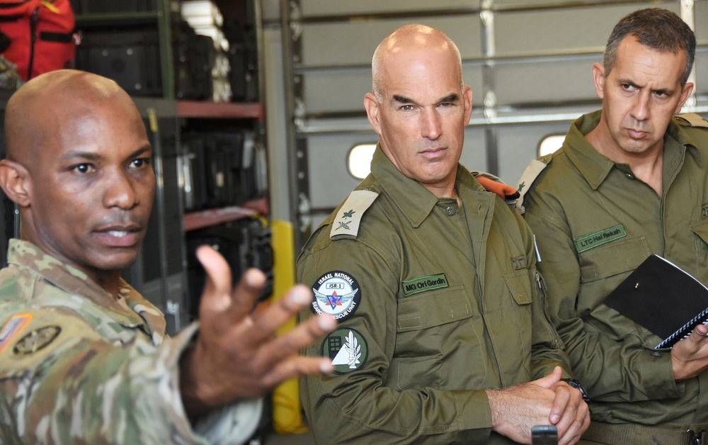 
                New York Army National Guard Maj. Del Gustave, assigned to the 24th Civil Support Team, briefs Israeli Maj. Gen. Ori Gordin, commander of the Israeli Defense Force Home Front Command, center, and Lt. Col. Hal Rekah, the Home Front Command liaison officer for the National Guard Bureau, during a capabilities brief of the CST for Home Front Command at Fort Hamilton, Brooklyn, N.Y. on June 28, 2021. Gordin met with National Guard members to discuss civil support operations and strengthen the security cooperation agreement between Home Front Command and the New York National Guard. (U.S. National Guard photo by New York Guard Captain Mark Getman)            